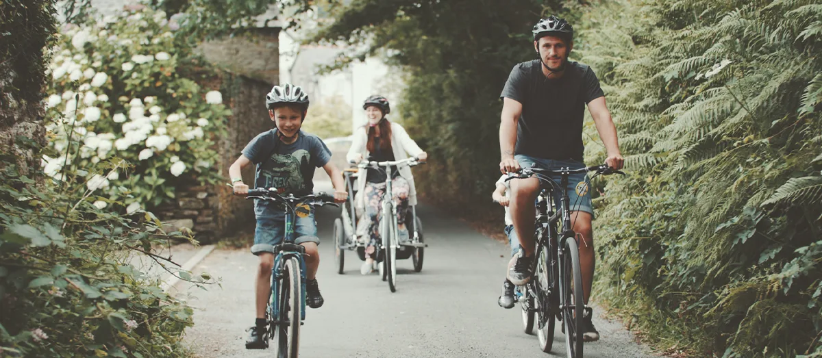Family cycling through the countryside