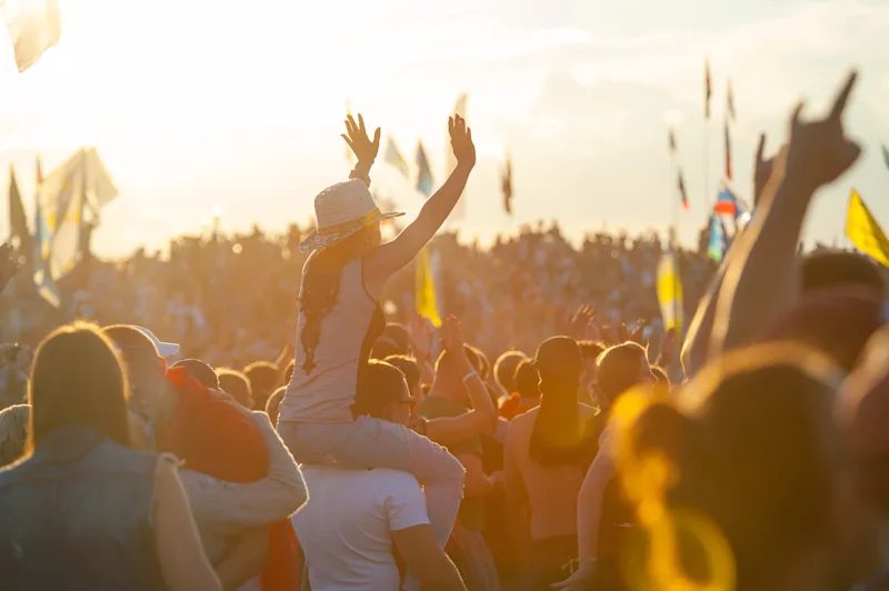 Crowd of spectators having fun at a summer music festival