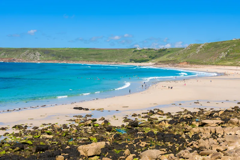 Sennen Cove beach and Cape Cornwall, beautiful bay with crystal clear turquoise water. Popular spot for surfing.