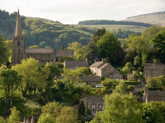 Hathersage village and church nestled in the rolling hillsides of the Peak District, Derbyshire