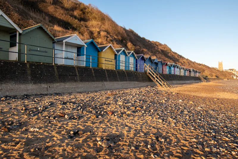 Beach huts by the sandy beach in Cromer, North Norfolk, England, UK
