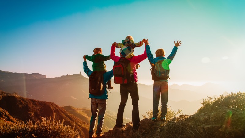 happy family travel in mountains at sunset