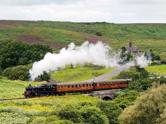 North Yorkshire Moors Railway. Vintage steam locomotive railway engine No.80072 pulls train south from Goathland