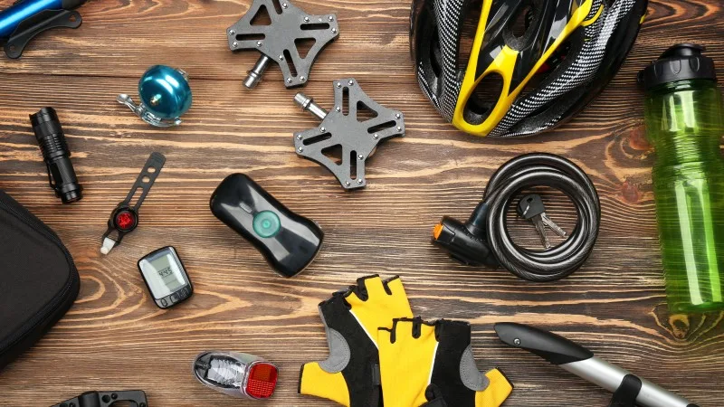 Set of accessories for cycling on wooden background