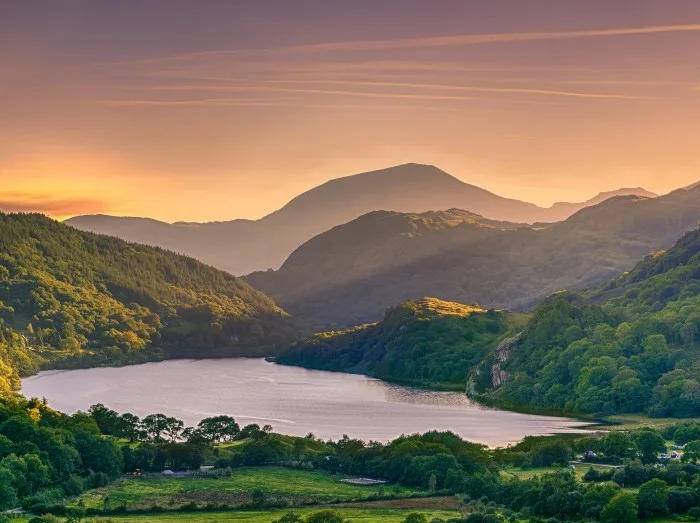 The Sun shining through a mountain pass over Llyn Gwynant, Snowdonia (Eryri)