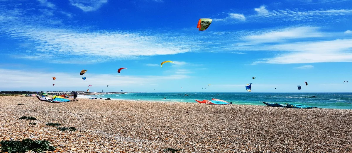 Kite surfers on the beach in Hayling Island on the Hampshire Coast, England