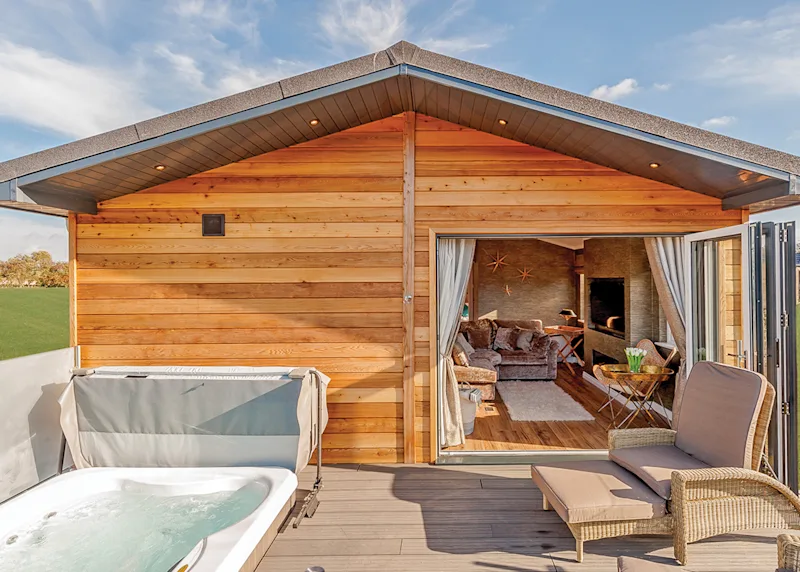 Hot tub lodge at Meadow Lodges Woodbridge (MDOW) in Bredfield, Woodbridge, Suffolk, England, UK