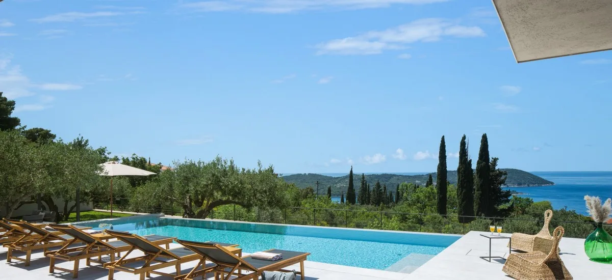  View of a luxurious pool in a holiday home and the sea in Croatia.