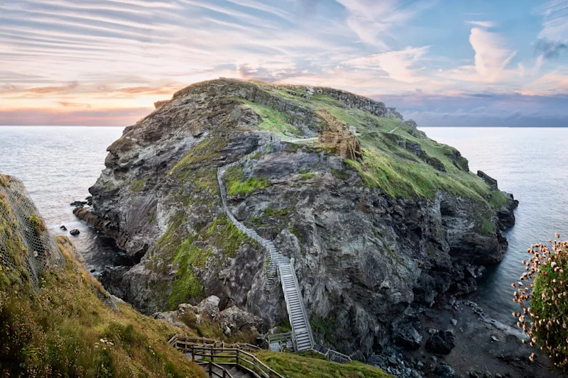 View of Tintagel Island and legendary Tintagel castle ruins at sunset