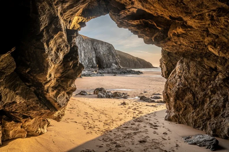 Absolutely beautiful landscape images of Holywell Bay beach in Cornwall UK during golden hojur sunset in Spring