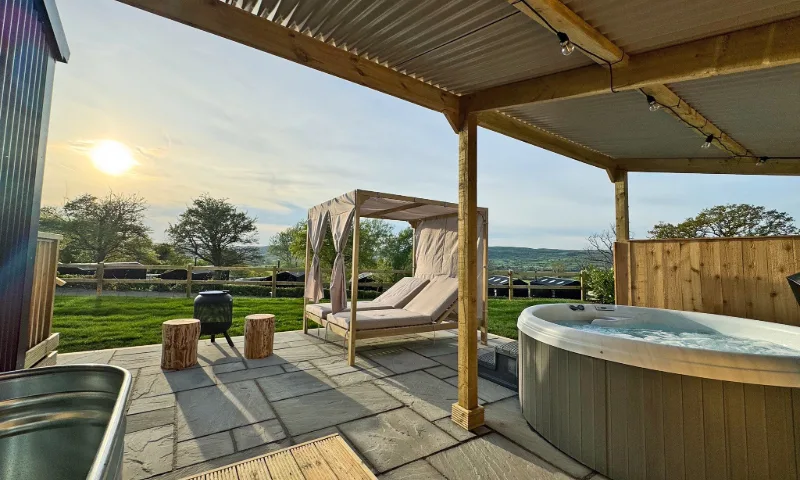 Blending sleek Scandi design with wild Welsh views, Retreat Lodge is a stylish escape with glass-fronted living, an outdoor hot tub, and front-row seats to the Cambrian Mountains.