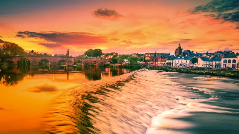 The River Nith and old bridge at sunset in Dumfries, Scotland.