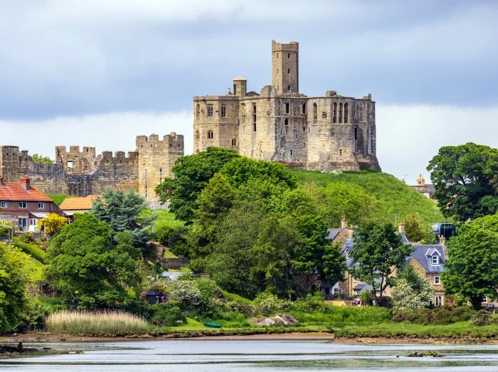 View over the river Coquet to the medieval Warkworth Castle and the village of Warkworth in Northumberland,