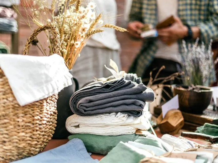 Textile, homemade goods, wicker basket on the summer outdoor vintage and fashion designer market