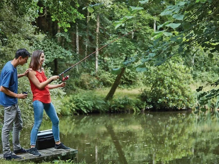 Couple fishing at Bulworthy Forest Lodges in Devon, UK
