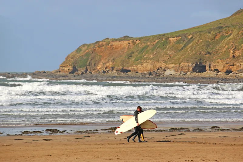 Surfers on Saunton Sands, North Devon, UK