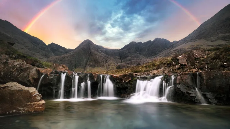 Scotland - Rainbow over Fairy pools waterfall in Isle of Skye,