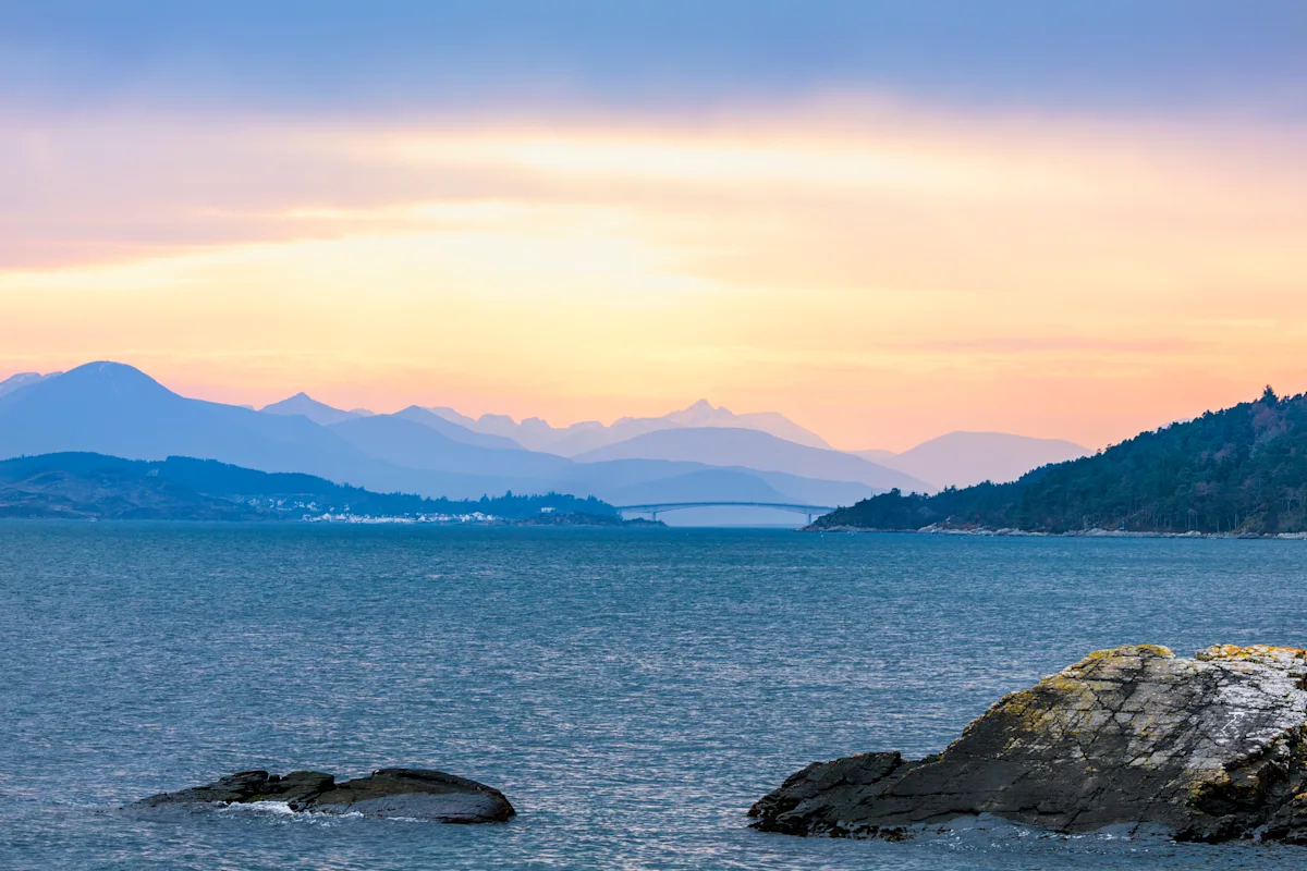 Sunset over the Skye Bridge crossing in Kyle of Lochalsh in the Highlands of Scotland, with the Cuillins in the background on the Isle of Skye