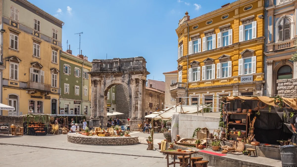 Ancient Roman triumphal arch or Golden Gate and square decorated for the Days of Antiquity - Pula 