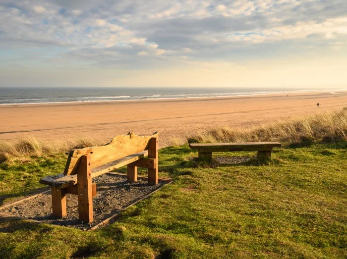 Bench overlooking Druridge Bay, located on the North Sea in Northumberland's AONB in England, it is a 7 miles long bay between Amble and Cresswell