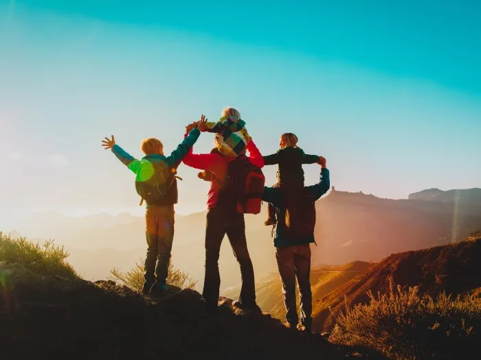 happy family travel in mountains at sunset