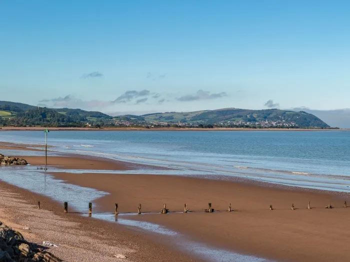 The beach in Blue Anchor, Somerset, England, UK - looking at the Bristol channel and Minehead in the background