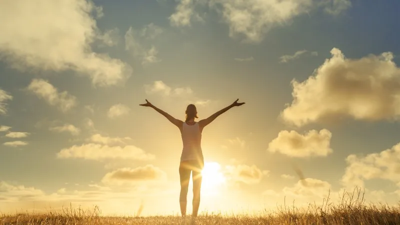 Happy woman with arms in air feeling free