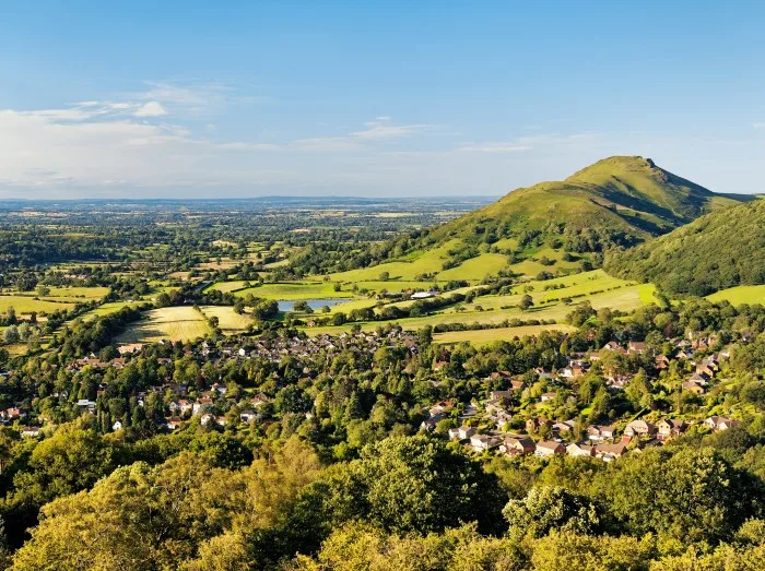 North from Ragleth Hill over Church Stretton village, Shropshire, England. Watling Street Roman Road and Caer Caradoc hill fort