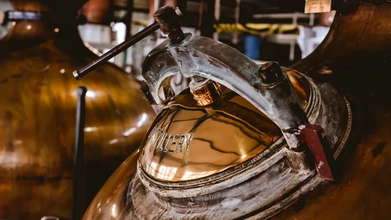 Detail shot of a copper stills main hatch. Shallow depth of field. Scotch distillery in Scotland.