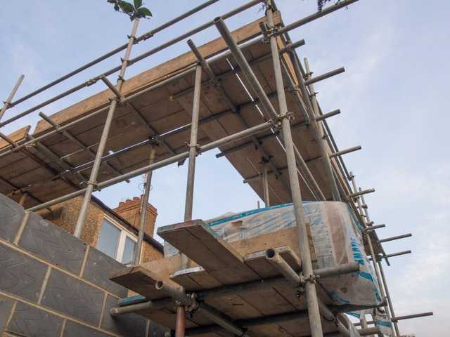 Wooden scaffolding portraying the construction of a house