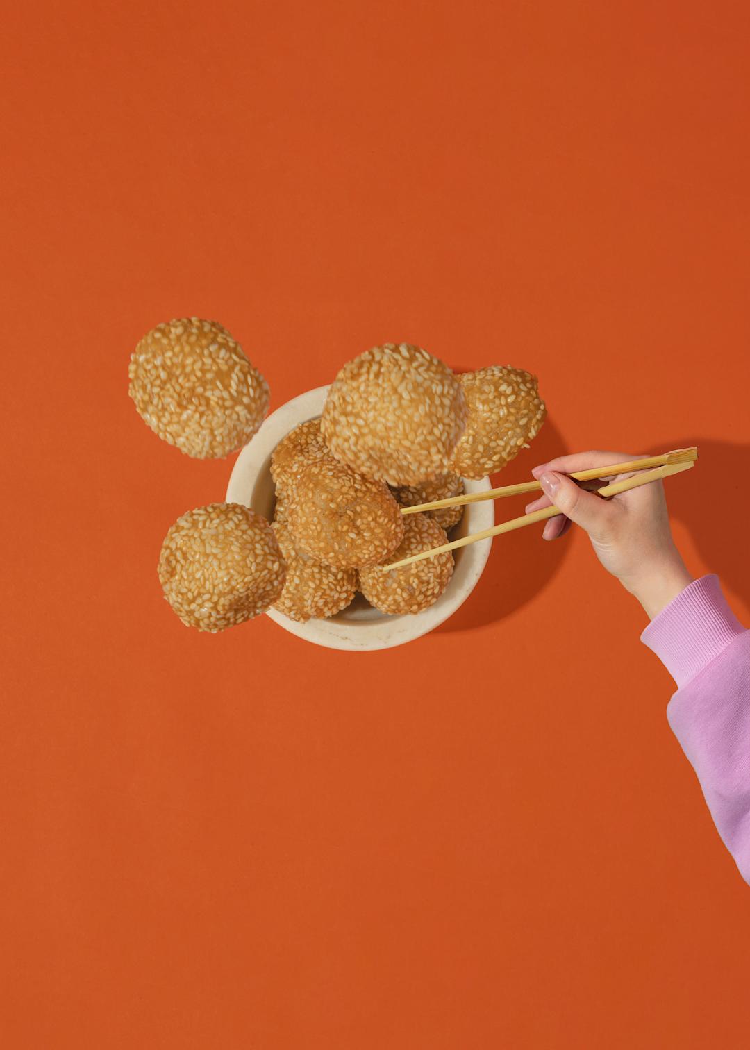 A pair of chopsticks grabbing some foods