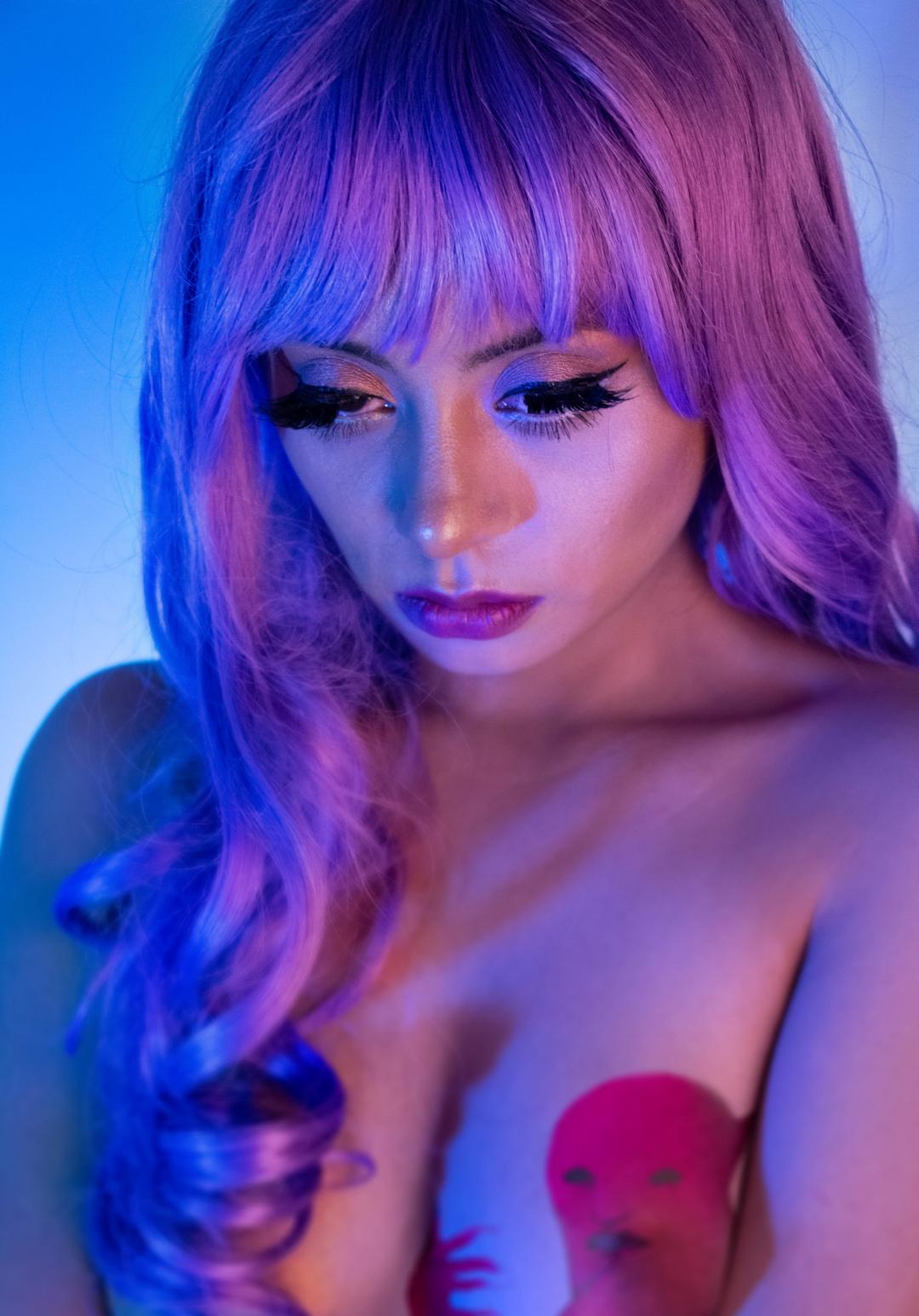 a woman in a purple wig