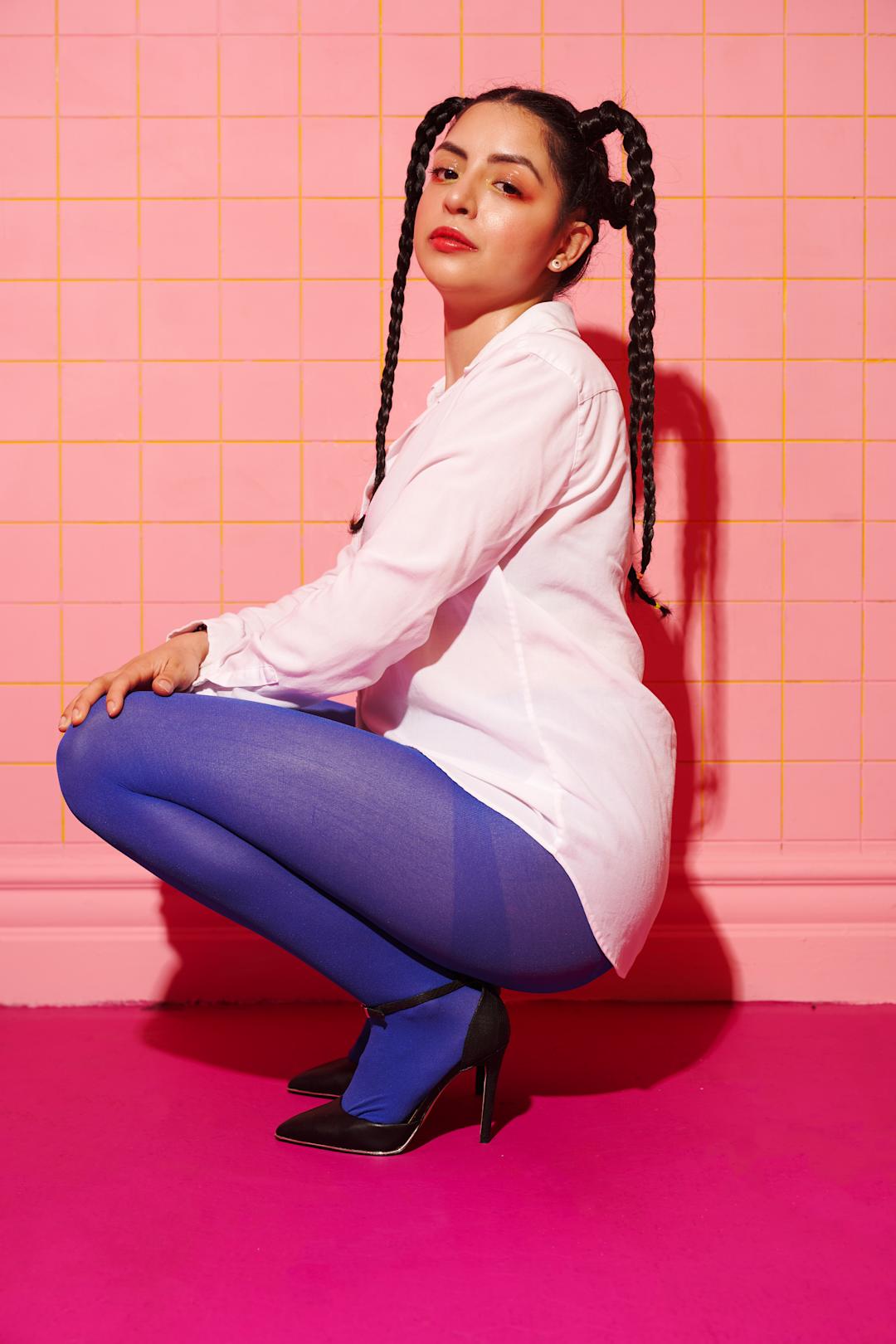 Woman kneeling, posing, looking at the camera