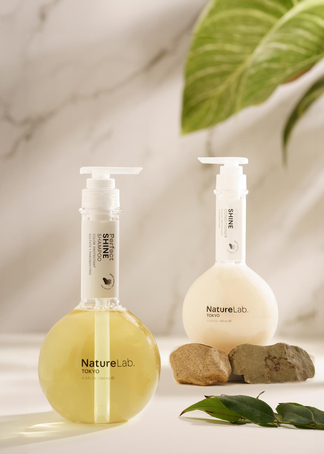 two bottles of cleanser against a marble background