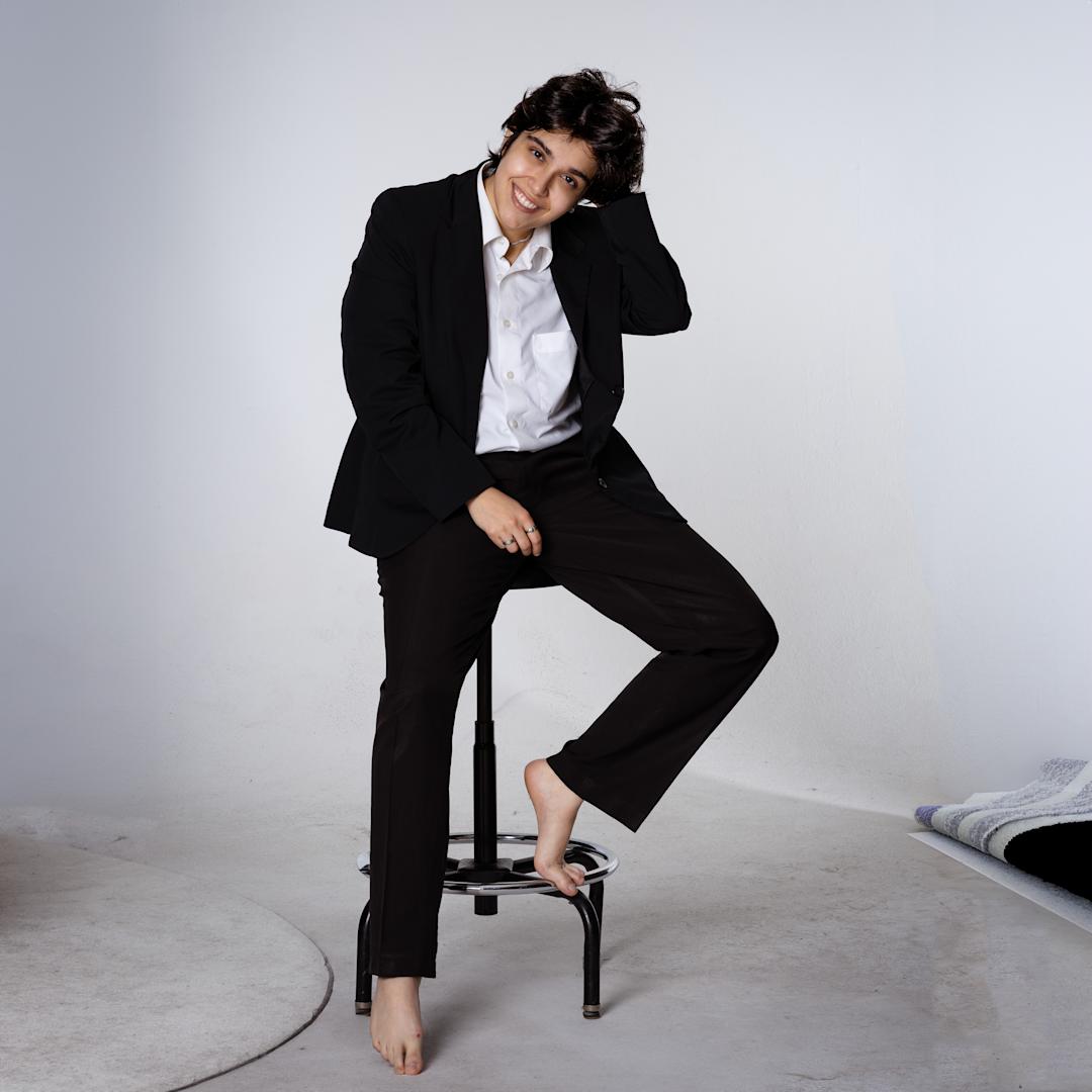 Termeh casually sitting on a stool