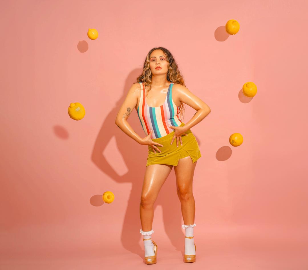 A woman surrounded by falling lemons