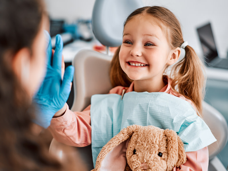 Niña sonriendo en el dentista