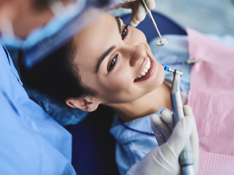 Woman at a dentist doing an dental stripping