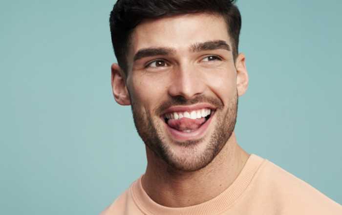 hombre sonriendo en fondo azul