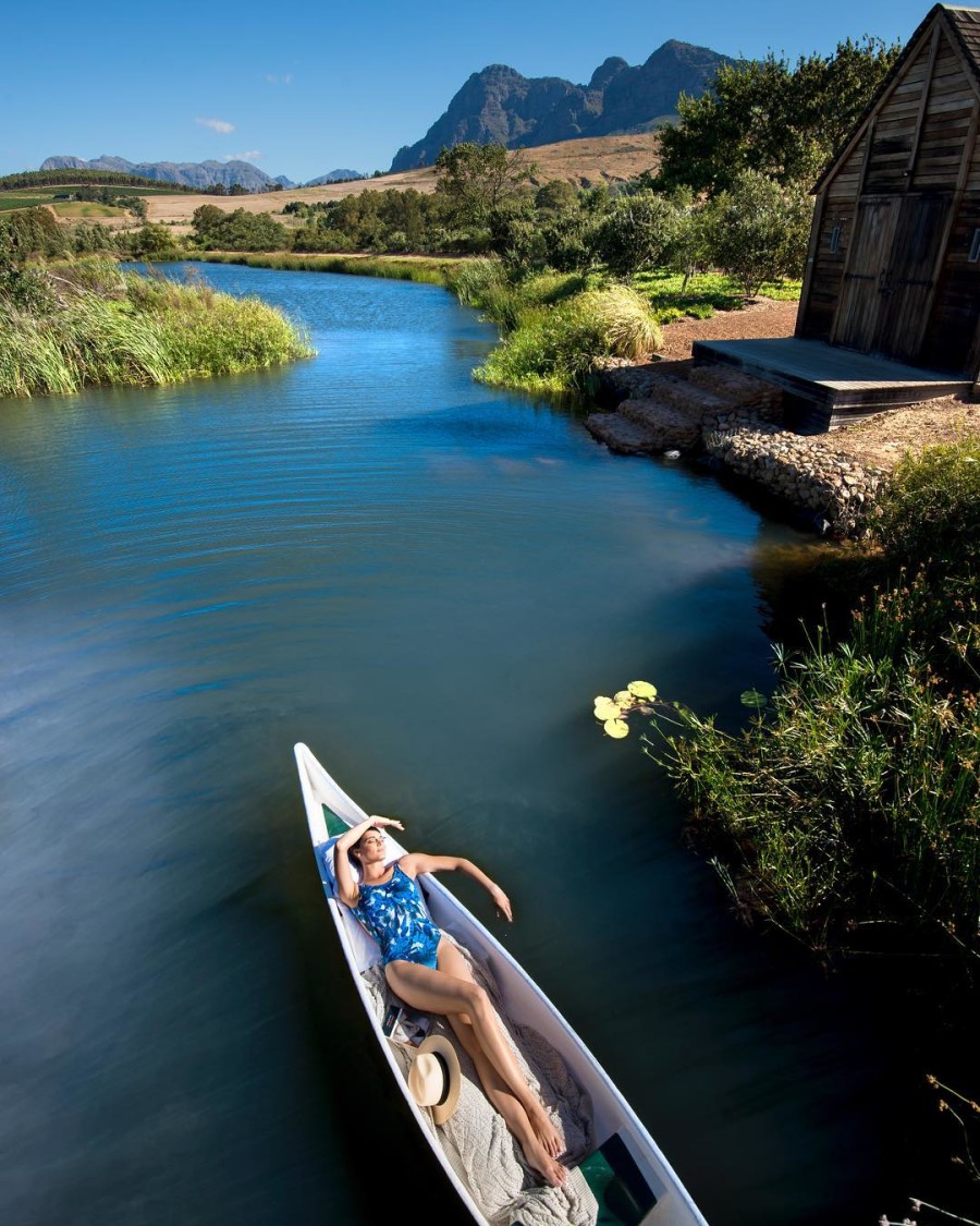 Woman Laying in River Boat Sunbathing on Luxury Safari in South Africa