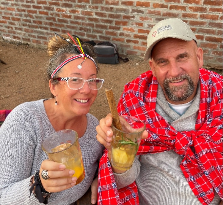 Couple Holding Cocktails & Smiling on Greatest Safari on Earth - ROAR AFRICA
