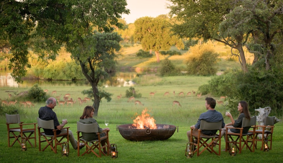 Guests Sitting Around Fire Table at Castleton, Award-Winning Private Safari Lodge