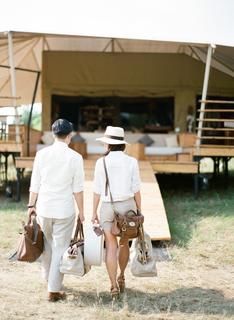 View of Two People's Backs Carrying Bags as they Walk into Luxury Villa in Botswana - ROAR AFRICA