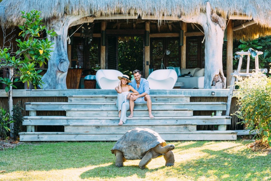 Couple Sitting outside Villa North with Tortoise - North Island Seychelles Luxury Villas