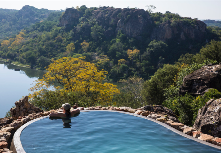 Woman in Pool Looking at Views from Luxury African Villa - ROAR AFRICA