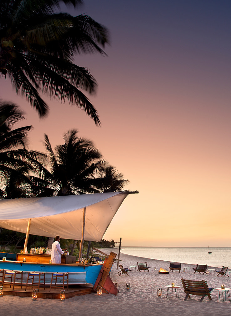Luxury Safari in Mozambique showing Beach Bar and Seating Area on Sand 