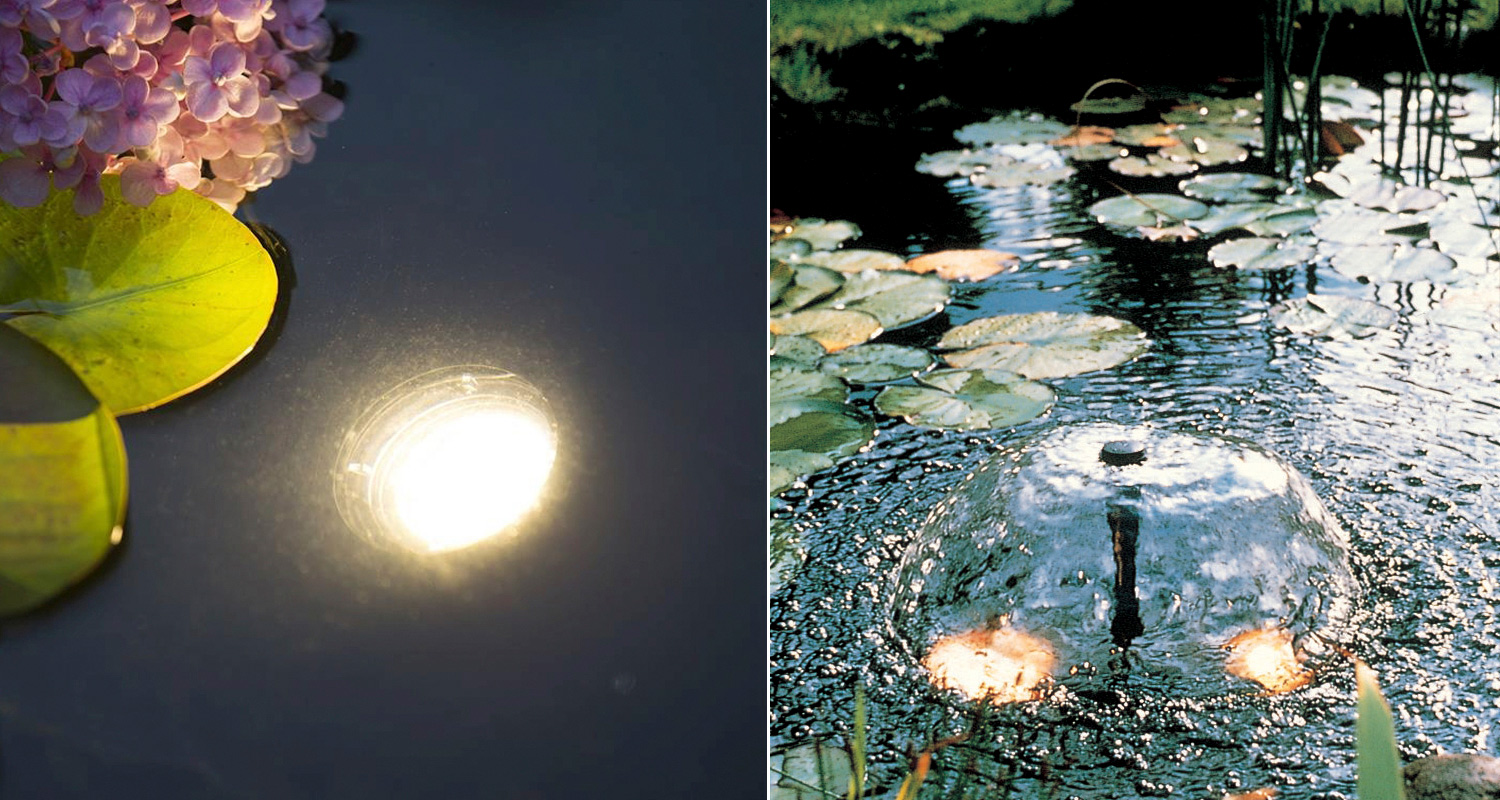 Pimeässä lammen pinnassa hohtavat upotetut valot, vihreät vesililjanlehdet ja pinkki hortensia.