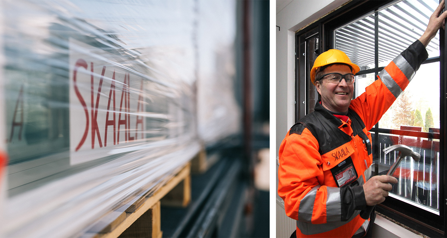 Oranssipukuinen työntekijä keltaisessa kypärässä vasaroi ikkunaa, vieressä SKAALA-ikkunarunkoja.