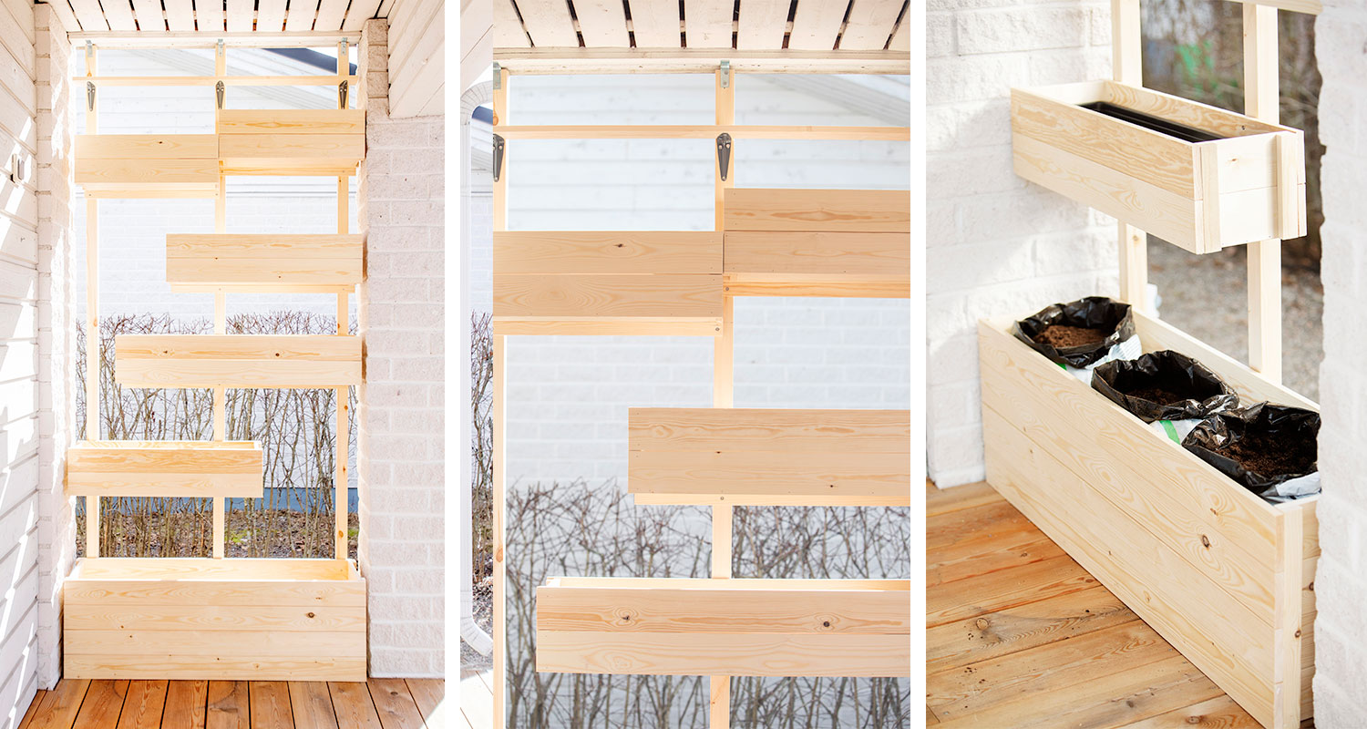 Portaikoinen vaalea puinen kukkalaatikko valkoista tiiliseinää vasten terassilla