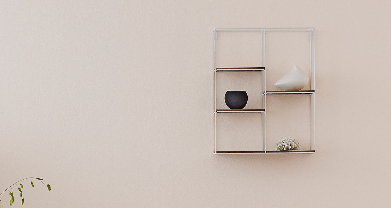 Cellon vaalea kevyennäköinen seinähylly puuterin värisellä seinällä. 